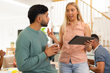 Discussing project, woman holding tablet and talking to man with coffee cup, start up business