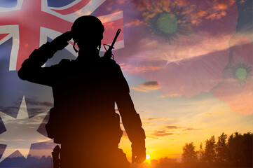 Silhouette of a soldier saluting against the sunset with Australia flag. Anzac Day. Remembrance Day concept