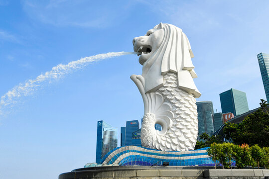 Singapore- July 15, 2024: Low-angle view of the Merlion with the background of modern skyscrapers in Marina Bay, Singapore, Merlion is the official mascot of Singapore.