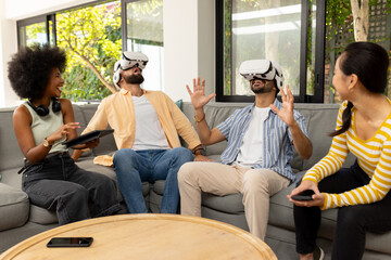 Using VR headsets, diverse friends enjoying virtual reality experience together indoors