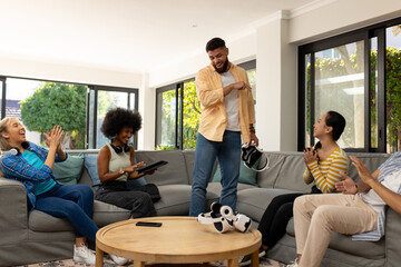 Friends enjoying VR gaming together, laughing and having fun in living room