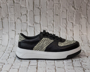 Elegant sneaker in eco-leather, black with animal print motifs, right view, for casual use