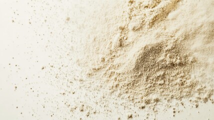 Fototapeta premium Close-up of finely milled flour scattered on a light surface, showcasing its texture and powdery consistency.