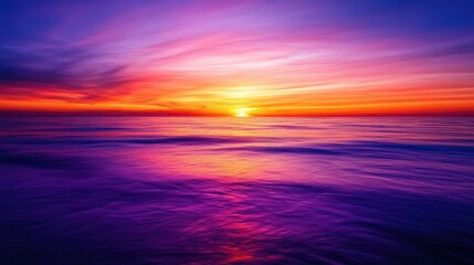 Fototapeta premium Vibrant gradient sunset with a peaceful horizon offering a warm blend of rich colors transitioning from orange to purple