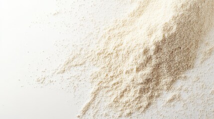 Close-up of wheat flour spread on white background, perfect for baking and cooking visuals.