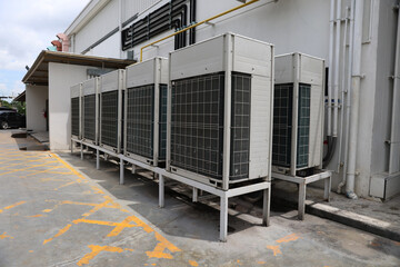 Air conditioner compressor installed in old building. Outdoor split wall type air conditioner...