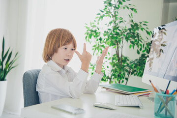 Photo of charming pretty nice boy learner sitting chair table studying from home apartment indoors...