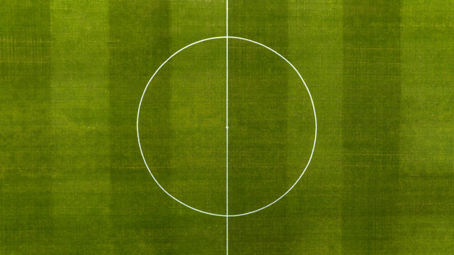 Aerial zenithal view on the center of a natural grass soccer field. Soccer stadium concept.