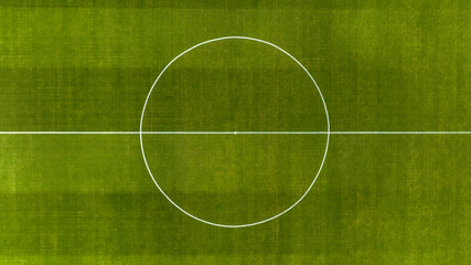 Aerial zenithal view on the center of a natural grass soccer field. Soccer stadium concept.