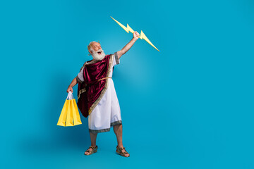 Photo of crazy powerful mythological god hand hold thunder bolt isolated on blue color background