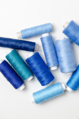Blue thread spools on white background.