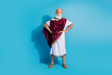 Full body photo of handsome senior male confident strong pose wear ancient greek god king dress isolated on blue color background