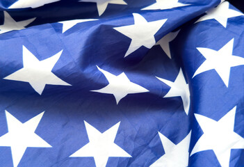 close up of white stars on blue background from the American stars and Stripes flag