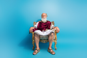 Full size photo of powerful mature man sit golden throne wear ancient roman emperor tunic isolated...
