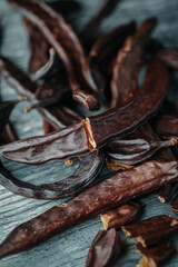 bunch of ripe carob pods on a table