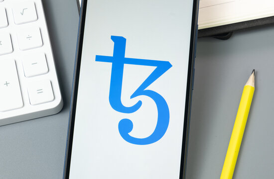 New York, USA - 30 August 2024: Tezos XTZ Logo on Phone Screen, Crypto Icon on Display