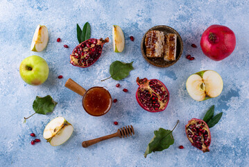 Rosh Hashana concept with honey, apple and pomegranate