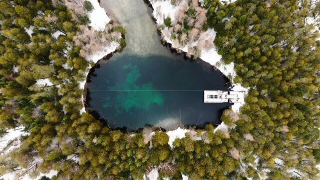 Spring Fed Pond Snow and Forest Winter Aerial