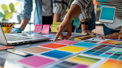 Design Team Brainstorming with Color Palette and Laptop