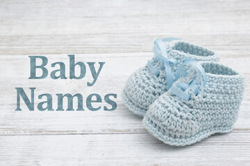Baby Names message with blue baby booties crochet on wood