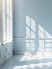 Obraz premium A serene and bright empty room with soft blue walls and gentle sunlight casting shadows through large windows creates peaceful atmosphere