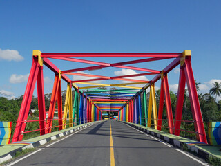 Colorful bridge in the middle of the rainforest in Indonesia
