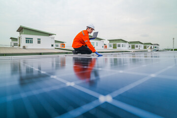 engineer man inspects construction of solar cell panel or photovoltaic cell by electronic device....