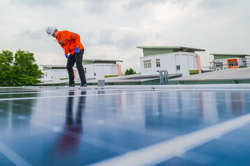 engineer man inspects construction of solar cell panel or photovoltaic cell by electronic device....