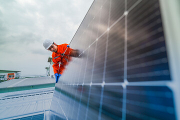 engineer man inspects construction of solar cell panel or photovoltaic cell by electronic device....