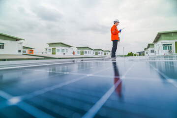 engineer man inspects construction of solar cell panel or photovoltaic cell by electronic device....