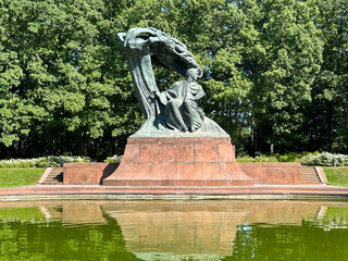 Beautiful view of monument of Frederic Chopin in the summer garden. Close-up. Warsaw. Poland.