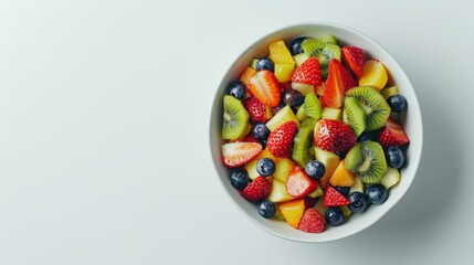 A bowl of fruit salad with strawberries, blueberries, kiwi, and oranges