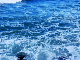 Sea background with waves and white foam