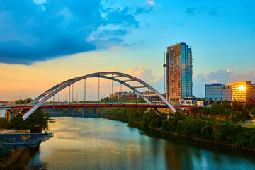 Naklejka premium Modern Bridge and Skyscraper at Golden Hour Nashville Riverfront Eye-Level