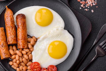Full English breakfast with boiled eggs, beans, sausages, tomatoes