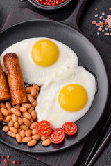 Full English breakfast with boiled eggs, beans, sausages, tomatoes