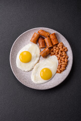 Full English breakfast with boiled eggs, beans, sausages, tomatoes