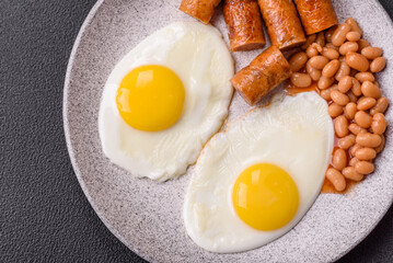 Full English breakfast with boiled eggs, beans, sausages, tomatoes