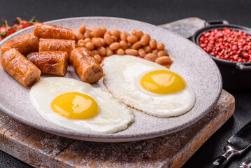 Full English breakfast with boiled eggs, beans, sausages, tomatoes