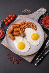 Full English breakfast with boiled eggs, beans, sausages, tomatoes