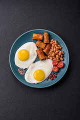 Full English breakfast with boiled eggs, beans, sausages, tomatoes