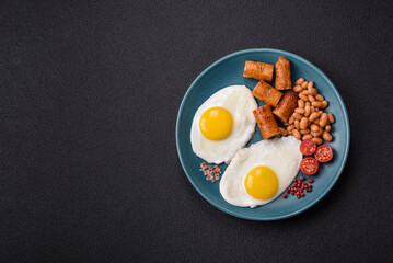 Full English breakfast with boiled eggs, beans, sausages, tomatoes