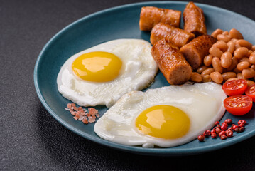 Full English breakfast with boiled eggs, beans, sausages, tomatoes