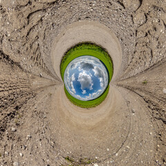 blue hole sphere or globe little planet inside sand or dry ground frame background with tractor...