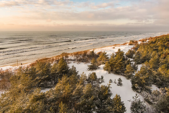 Aerial view of the Baltic Sea shore line near Klaipeda city, Lithuania. Beautiful sea coast on chilly and snowy winter day.