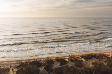 Aerial view of the Baltic Sea shore line near Klaipeda city, Lithuania. Beautiful sea coast on chilly and snowy winter day.