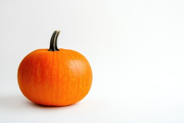 Obraz premium Vivid Orange Pumpkin with Simple White Backdrop