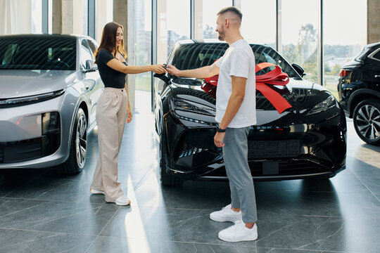 The process of handing over the keys to a new car at a car dealership