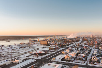 Obraz premium Aerial view of Klaipeda city port area and it's surroundings on sunny winter evening. The Old town of Klaipeda, Lithuania in evening light at wintertime.