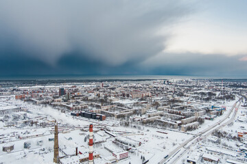 Aerial view of biofuel boiler-house plant facilities with steaming chimneys on winter day in...